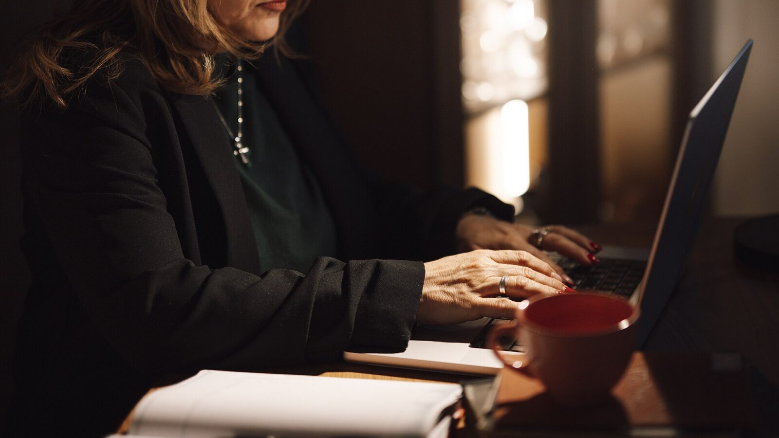 Hands typing on a laptop