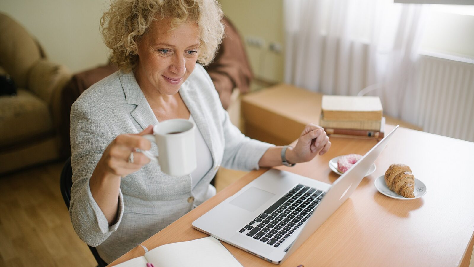 A professional working on a laptop in an office